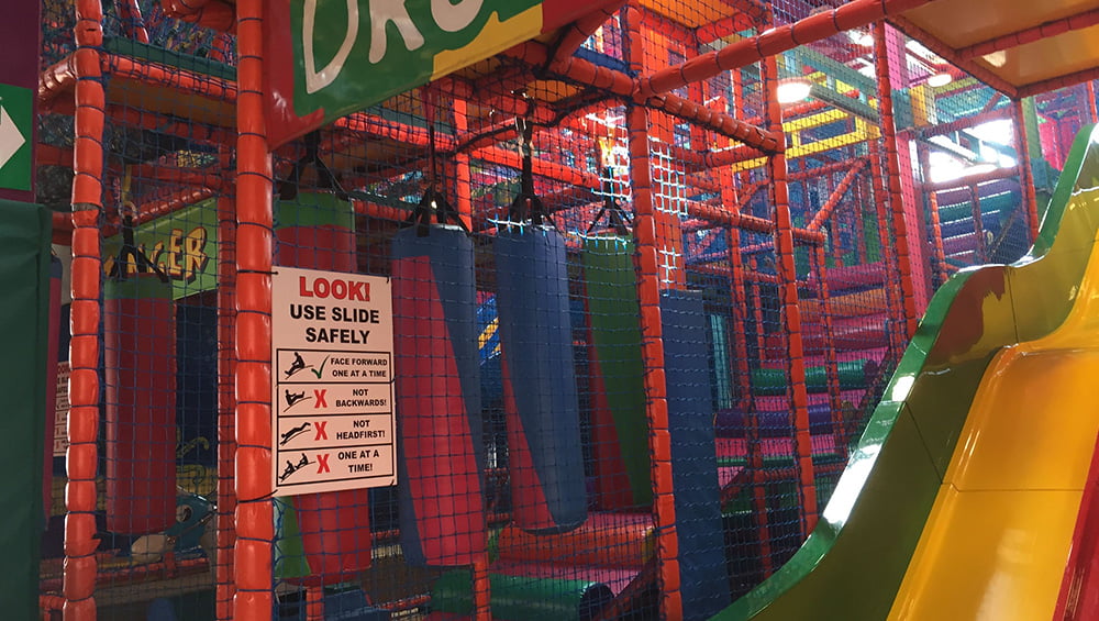 A colorful indoor playground with a slide.