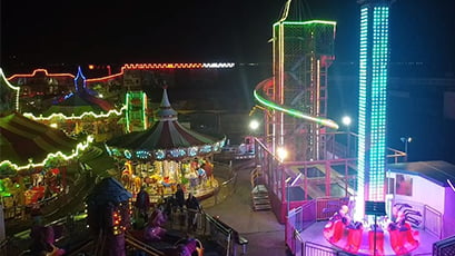 Amusement rides at night in a park.
