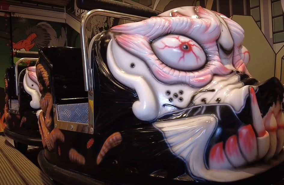 A bumper car with a scary face on it.
